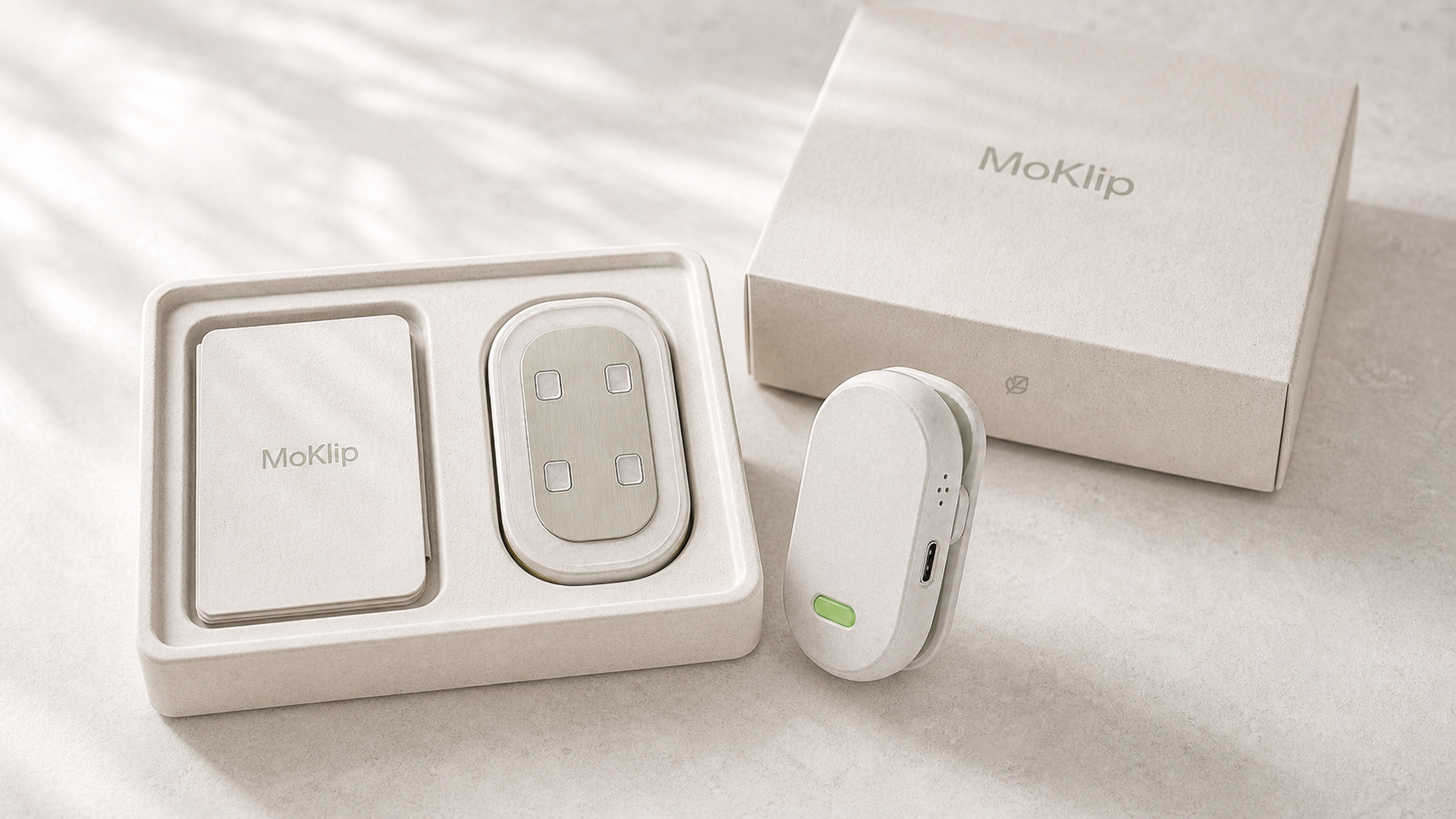 Conceptual MoKlip packaging with a quick-start guide inside the box and a device with a 1-2-1 acoustic grille and consistently positioned USB-C port